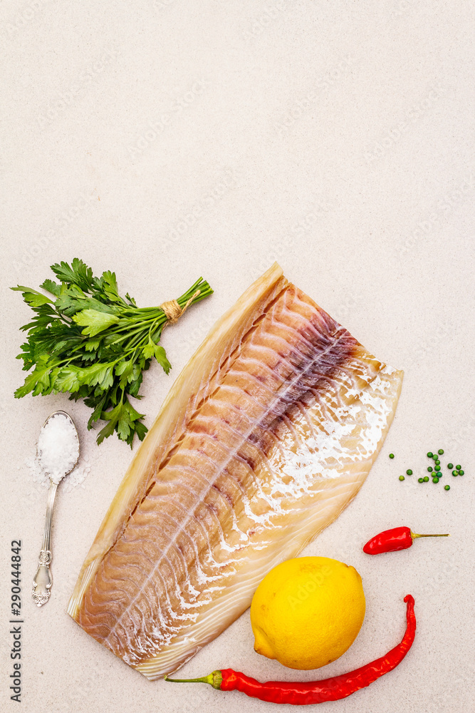 Raw cod loin fillet with lemon, sea salt, chili and cayenne pepper, parsley Raw cod loin fillet with lemon, sea salt, chili and cayenne pepper, parsley