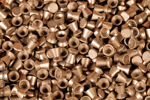 golden lead air-gun pellets close-up background texture, selection of pellets of an Air rifle. Close up. gun control background. Concept of shooting, pneumatic weapon, Air rifle parts and copy space.