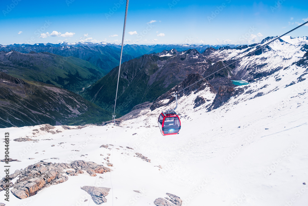 Fototapeta premium cable car on the snow mountains in winter background