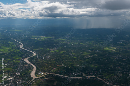 Pouring rain from low altitude Cumulonimbus clouds above Lamphun province of Thailand photo