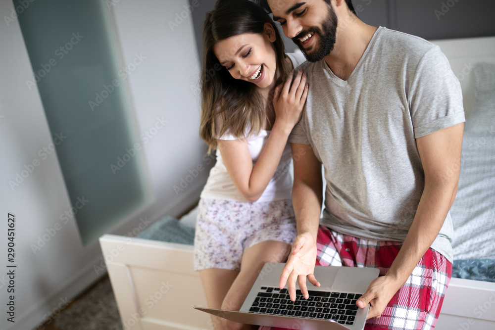 Young couple relaxing with laptop at home. Love,happiness,people and fun concept.