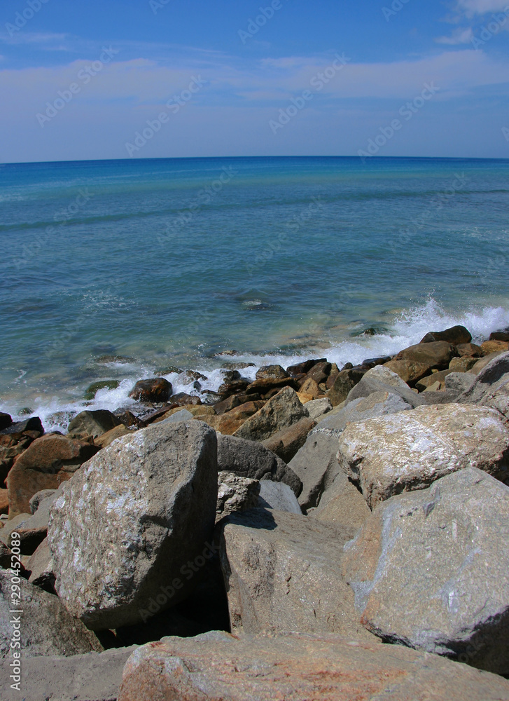 Fototapeta Rock on the beach with blue sea and sky