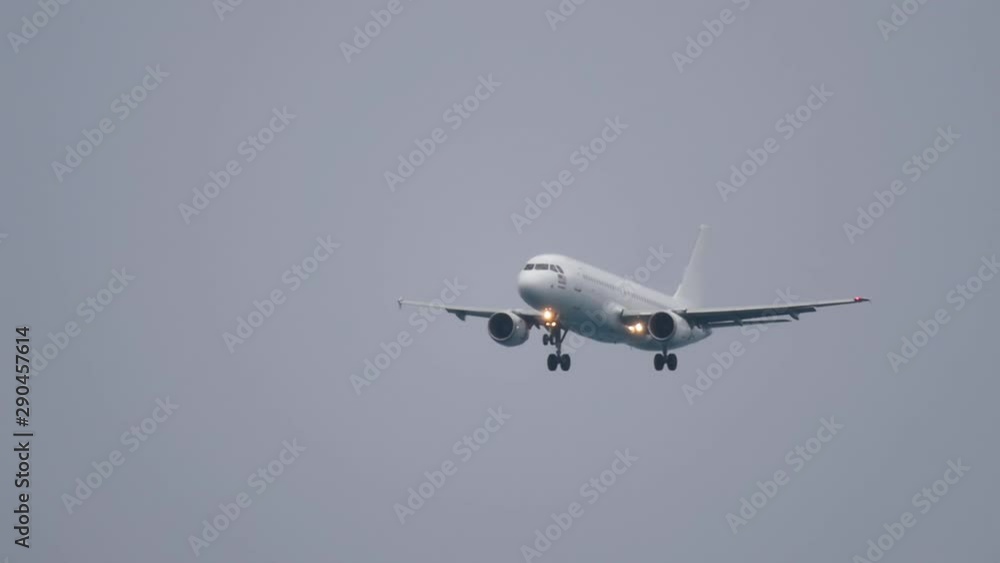The plane flies in rainy cloudy weather