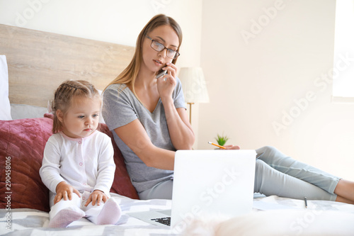Working mother with her dau...