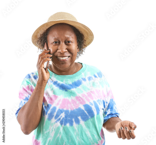 Portrait of African-American woman talking by phone on white background © Pixel-Shot