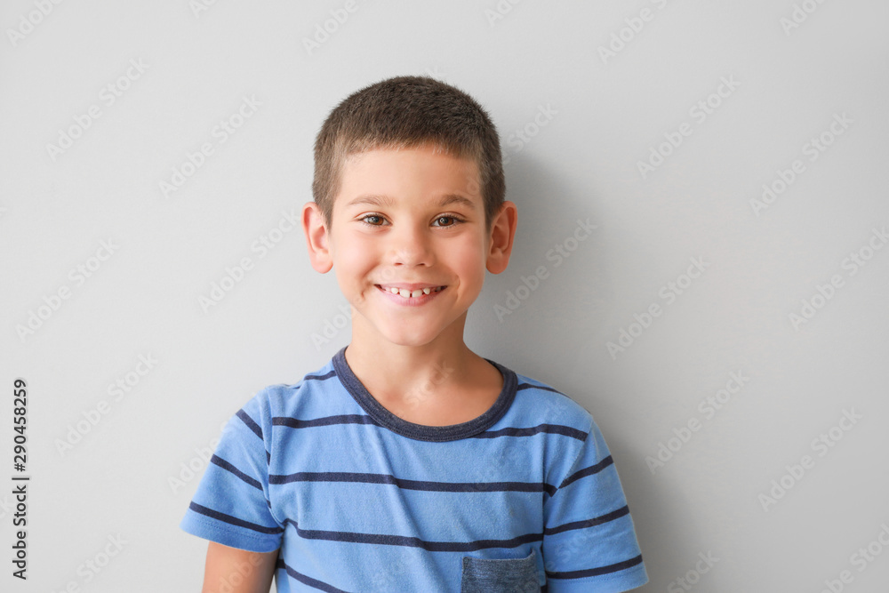 Portrait of happy little boy on light background - obrazy, fototapety, plakaty 