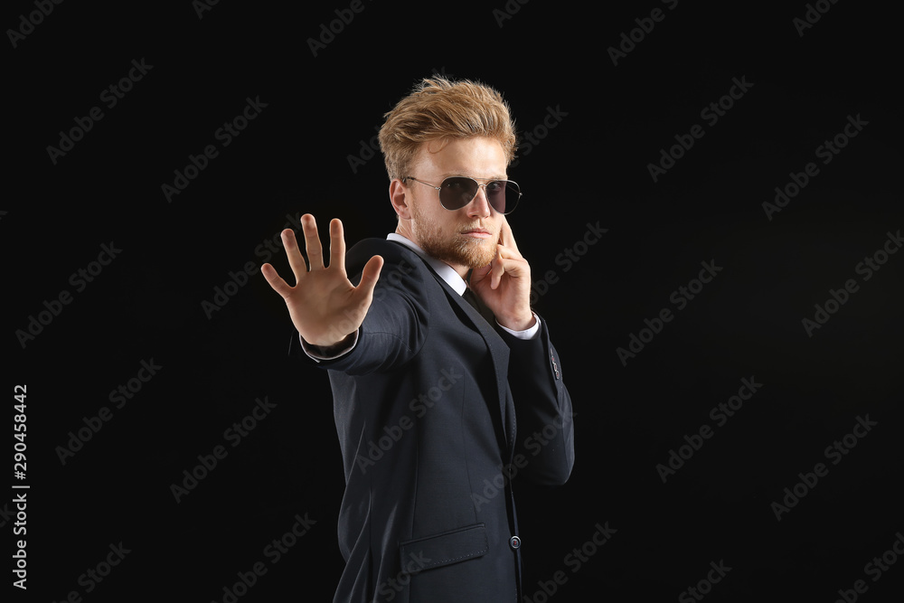 Handsome security guard on dark background Handsome security guard on dark background