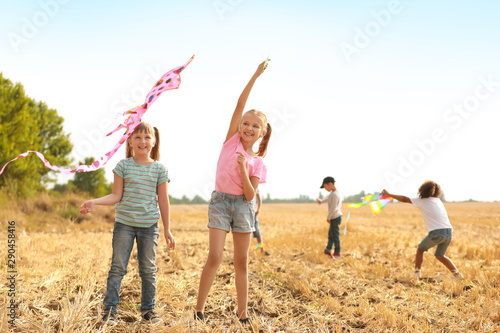 Little girls flying kite outdoors