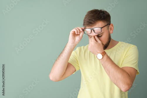 Stressed young man on color...