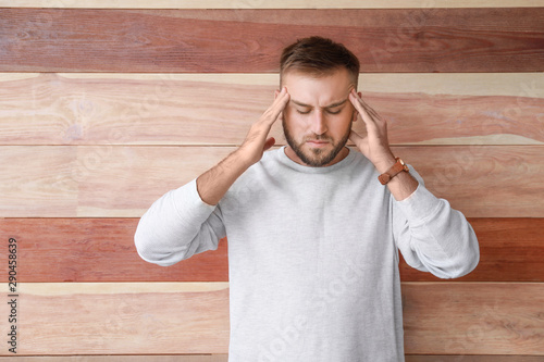 Stressed young man on woode...