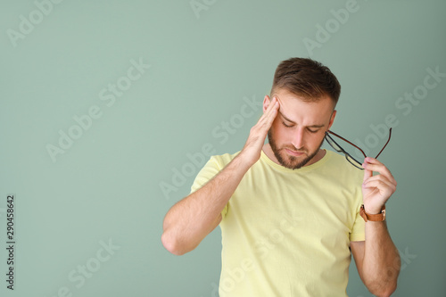 Stressed young man on color...
