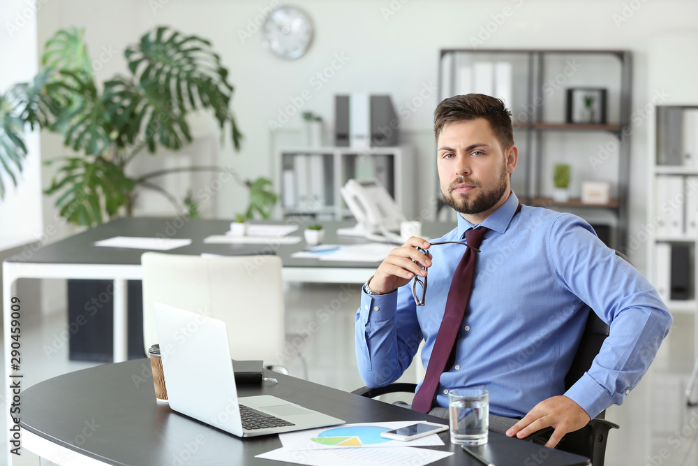 Portrait of businessman working in office Portrait of businessman working in office