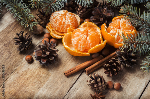 Tangerines, Christmas tree branches, cones, spices on a wooden background. Concept of New Year and Christmas, Christmas drink Mulled wine.
