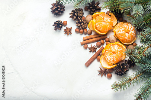 Mandarins, Christmas tree branches, spices, cinnamon, cones on a white stone background. Concept of Christmas, New Year, Mulled Wine, Winter, Holidays.