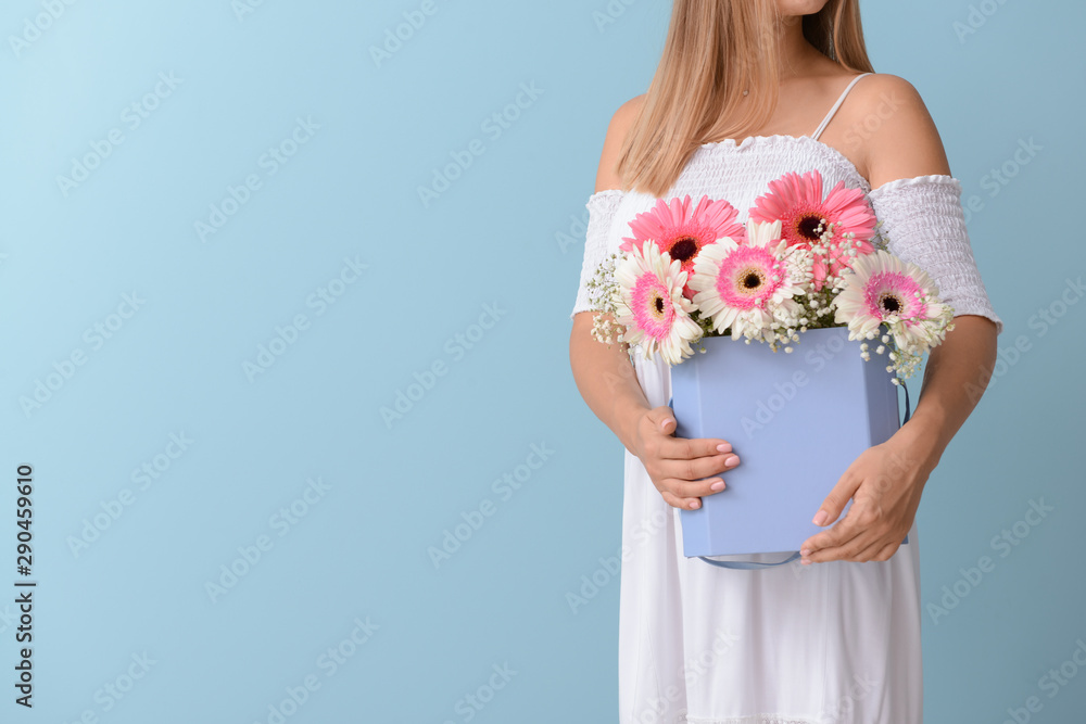 Woman with bouquet of beautiful gerbera flowers on color background