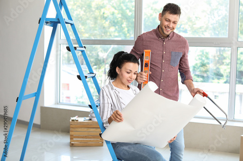 Happy couple doing repair i...