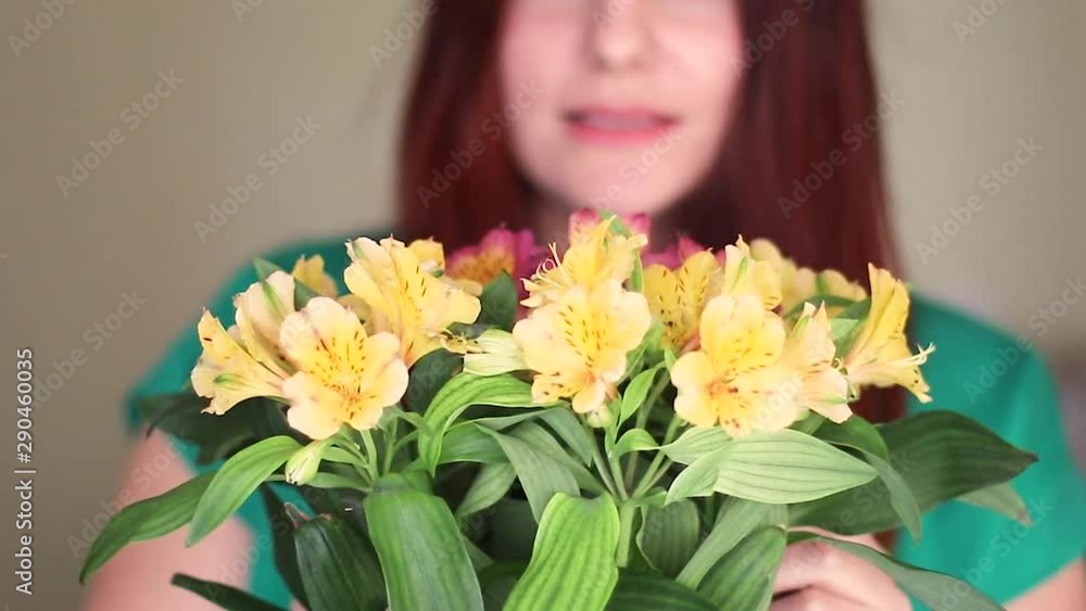 Female florist puts flowers in a glass vase. Woman With Flowers At Valentines Day Female florist puts flowers in a glass vase. Woman With Flowers At Valentines Day