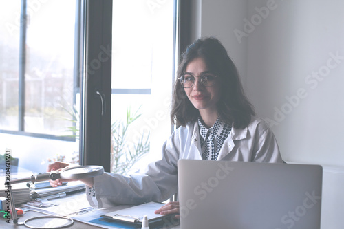 Young female doctor working at the office.