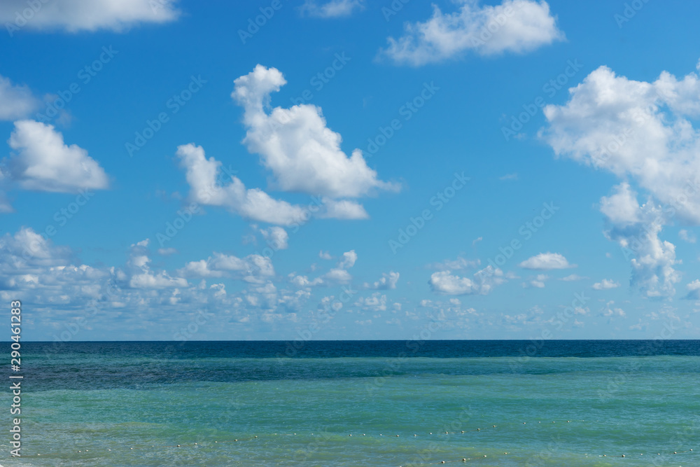 Seascape with tricolor water and cloudy sky.