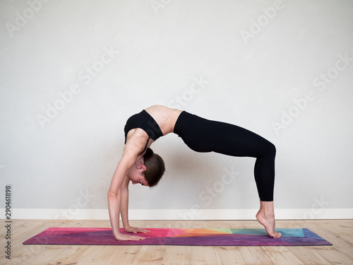 Attractive european girl doing yoga exercise