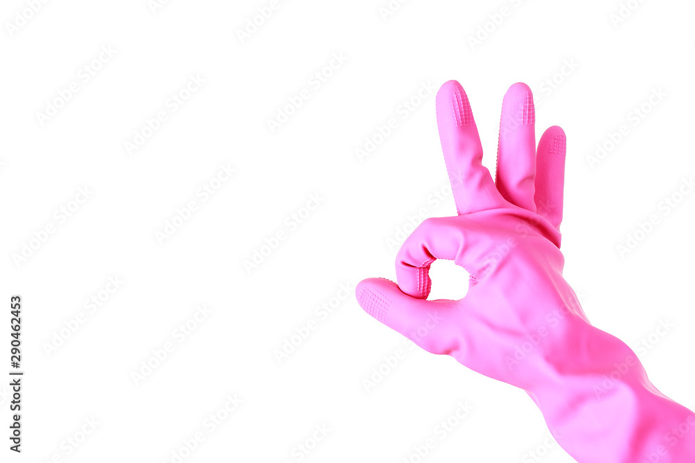 Fototapeta premium Female hand in pink rubber gloves shows the sign OK on a white background