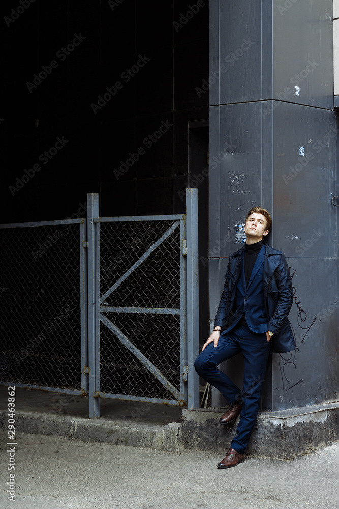 portrait of an attractive young man in a blue suit in the city portrait of an attractive young man in a blue suit in the city