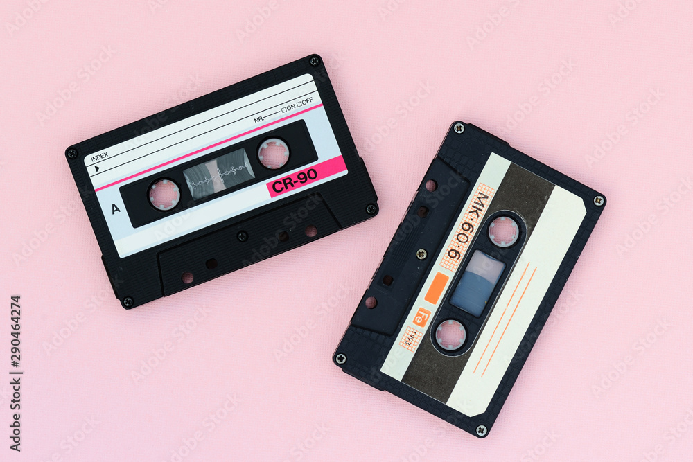 Fototapeta premium Old audio tape cassettes on a pink background. Top view, old technology concept