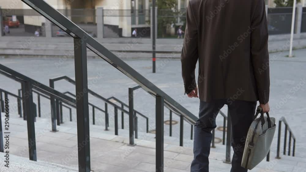 Businessman descends the stairs in a big city Businessman descends the stairs in a big city