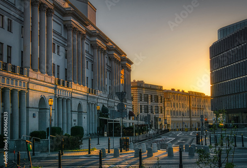 empty street in the early morning illuminated by the first rays of the sun, city center with limited car traffic © Jarek Witkowski