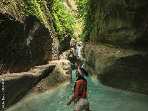 Photography woman alone on the green canyon road at the middle of tropical jungle on the way