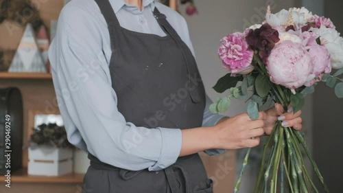 Florist making fresh flower bouquet in flower shop