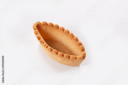 Oval small form of unleavened pastry for serving snacks. Capacity of dough for filling. The form of the dough. Macro photo on a white background. Top view. Copy space.
