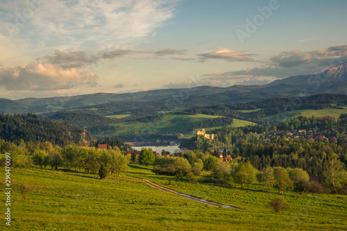 Panorama of snowy Tatra mountains and castle in Czorsztyn during spring sunset, Malopolskie, Poland