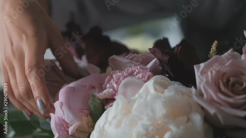 Florist making fresh flower bouquet in flower shop
