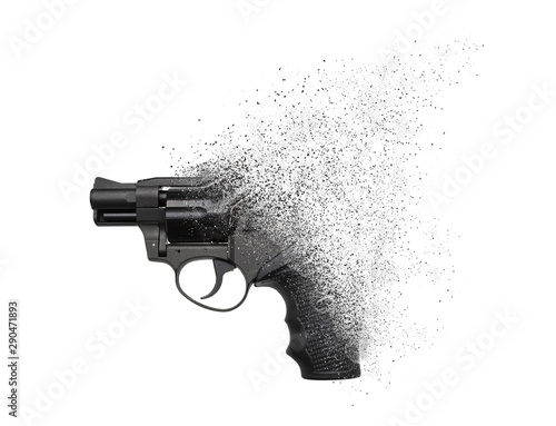 Fototapeta A gun crumbling into particles in space isolate on a white background