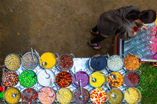 Pots full of traditional Asian dessert jellies, sweet beans, fruits. Metal pots containing various kinds of colorful sweet soups Che hem Hue Vietnam