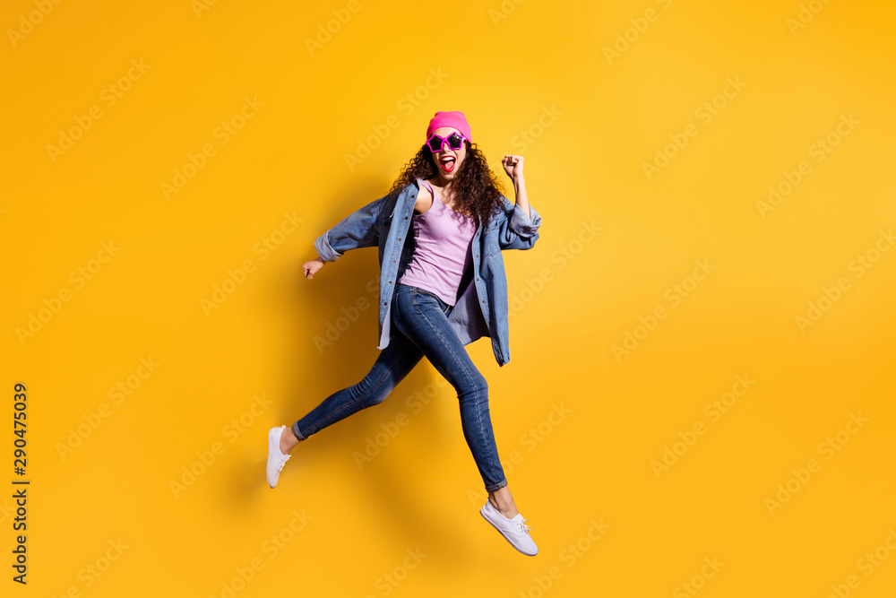 Full body photo of stylish wavy lady jumping high running quickly to shopping center wear casual trendy clothes isolated yellow color background