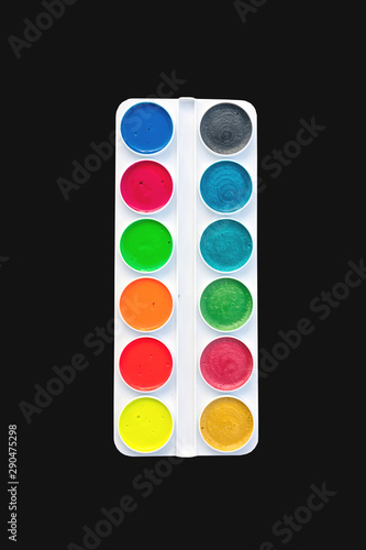 New bright fluorescent and pearlescent watercolor paints in a white plastic box. 12 colors. isolated on black background
