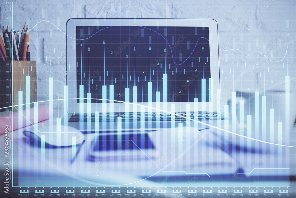 Stock market chart hologram drawn on personal computer background. Double exposure. Concept of investment. Stock market chart hologram drawn on personal computer background. Double exposure. Concept of investment.