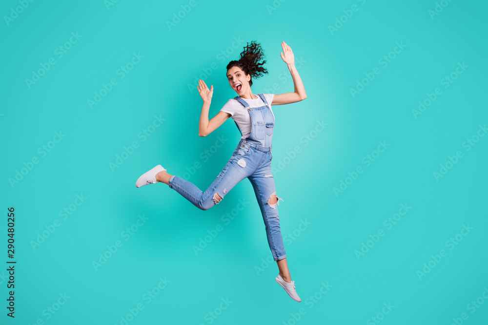 Full length body size view of her she nice attractive lovely cheerful cheery wavy-haired girl jumping celebrating having fun free time isolated on bright vivid shine vibrant green turquoise background