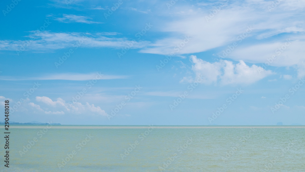 The sea with blue sky and white clouds