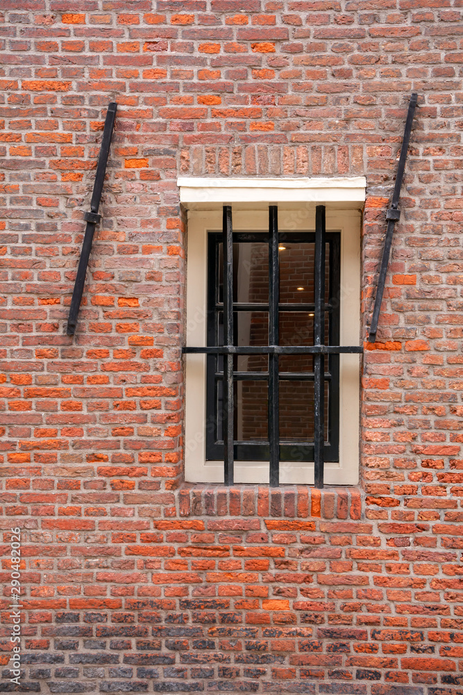 Window with lattice. Orange brick wall