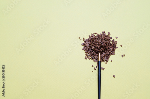 Instant granulated coffee in spoon on yellow background