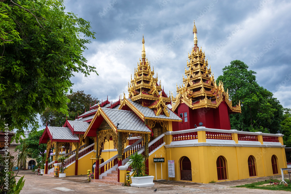 LAMPANG, THAILAND -  Augustr 3, 2019:Chum is a Buddhist temple (Wat) Is an old Burmese art temple of chapel roof is carved of with beautiful golden pattern of a pagoda in Lampang, Thailand.