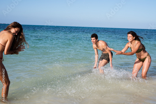Boy and girl splashing each other in the sea