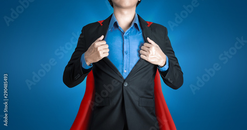 Super business man wears black suits and red robes with super heroes coaching concept on shine blue background and smart. Investors receive a lot of profits with business success. photo