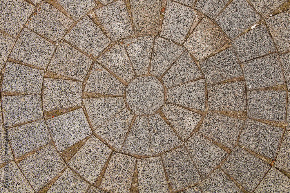 The texture of the stones. Paved stone on the sidewalk in the center of the city laid out in a circle.