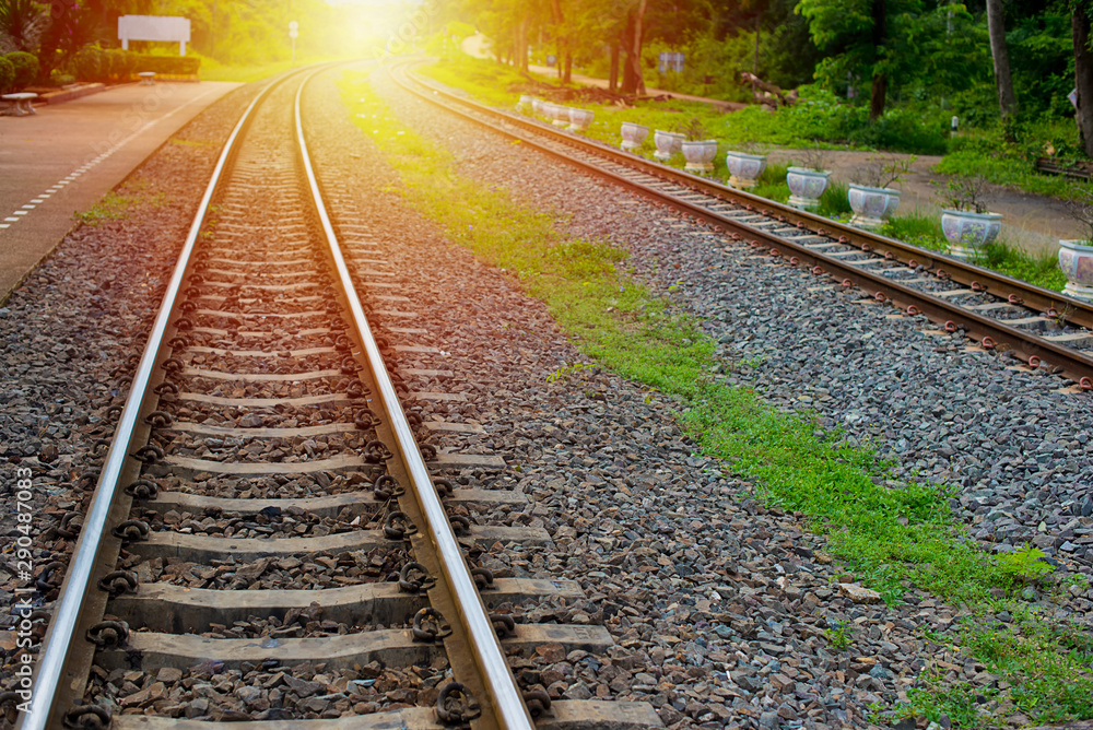 Obraz premium Railroad at sunset, Railway station with colorful blue sky, Industrial landscape with railroad, Railroad travel, railway tourism. Blurred railway, Transportation and Rural industrial concept.