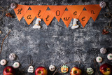 Creative Halloween background with themed marshmallows and apples. Place for text.