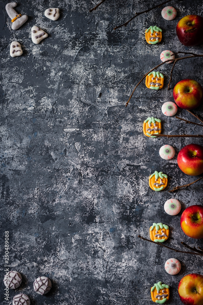 Creative Halloween background with themed marshmallows and apples. Place for text.